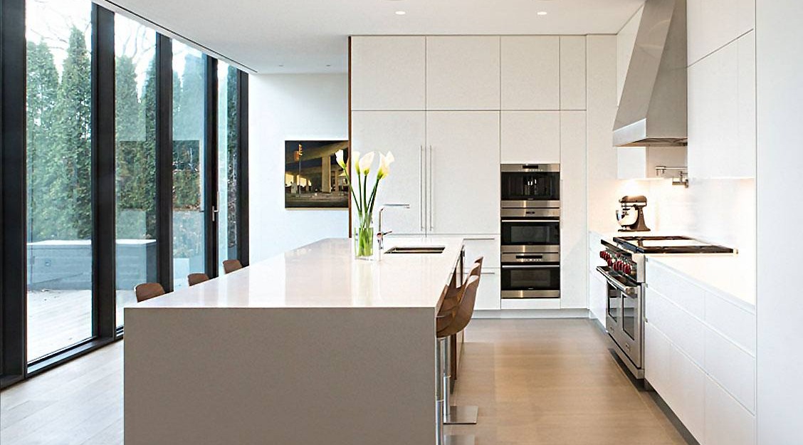 modern home kitchen with large window pans looking in backyard and kitchen island in Toronto